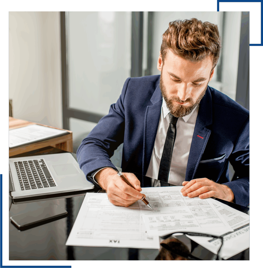 Man in suit working on documents.