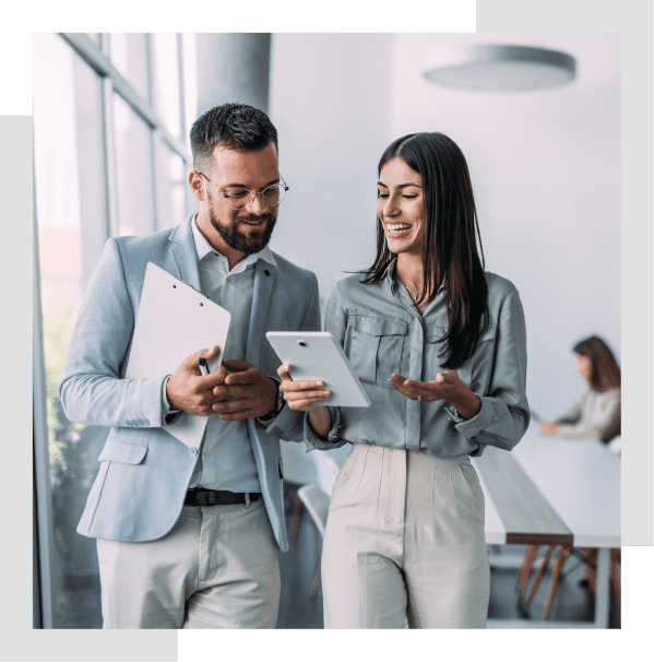 Business colleagues discussing with tablet and clipboard.