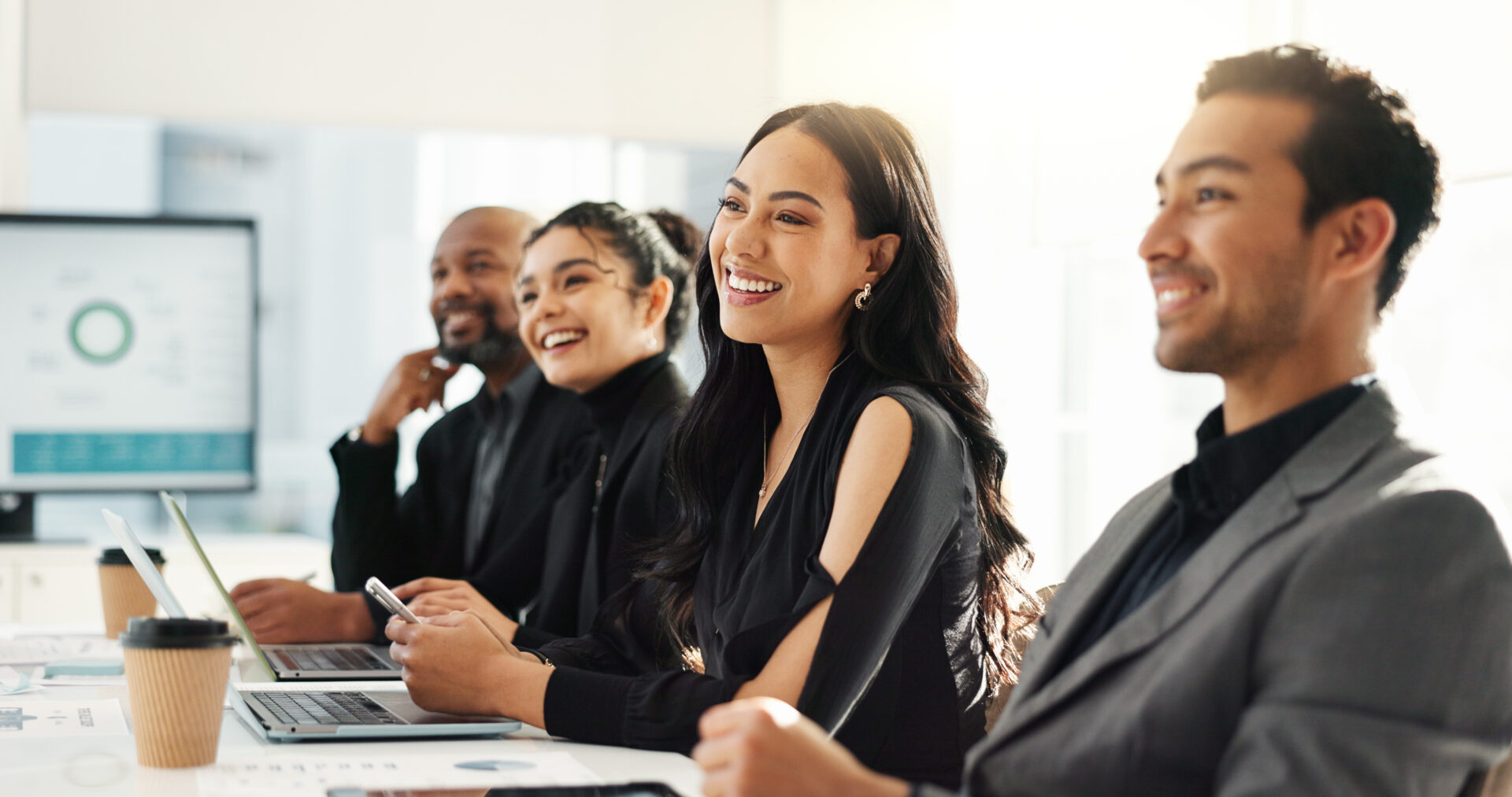 People smiling during a business meeting.